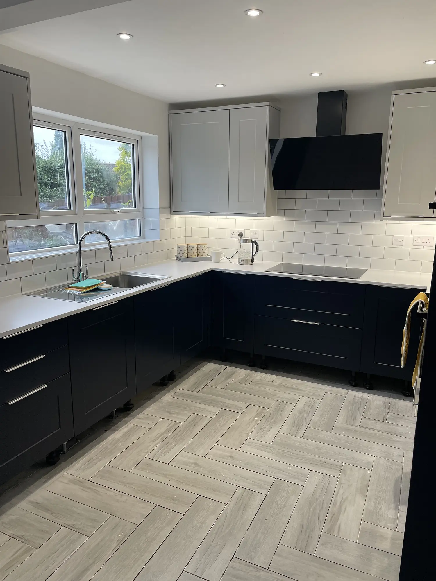 Navy and white shaker kitchen with illuminated splashback